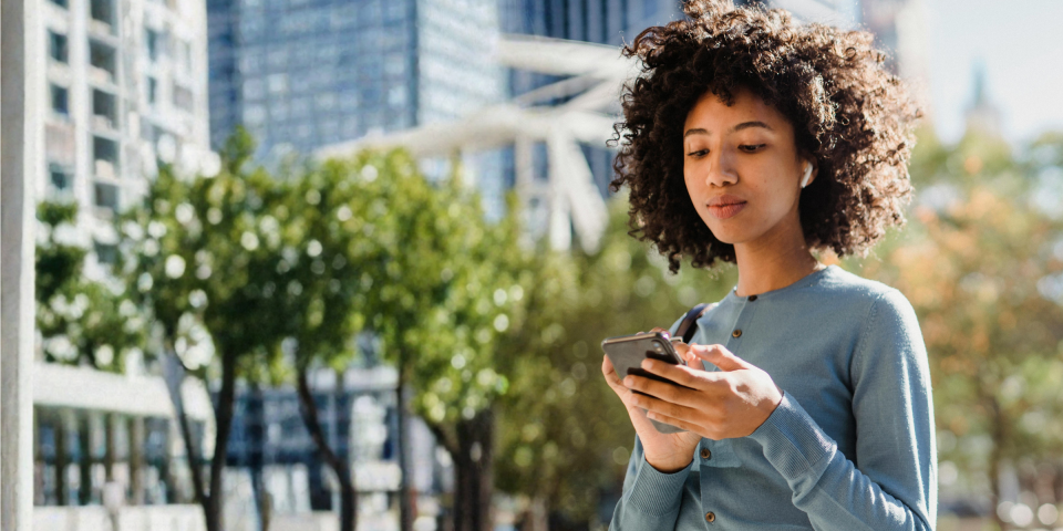 Image of a woman looking at her phone.